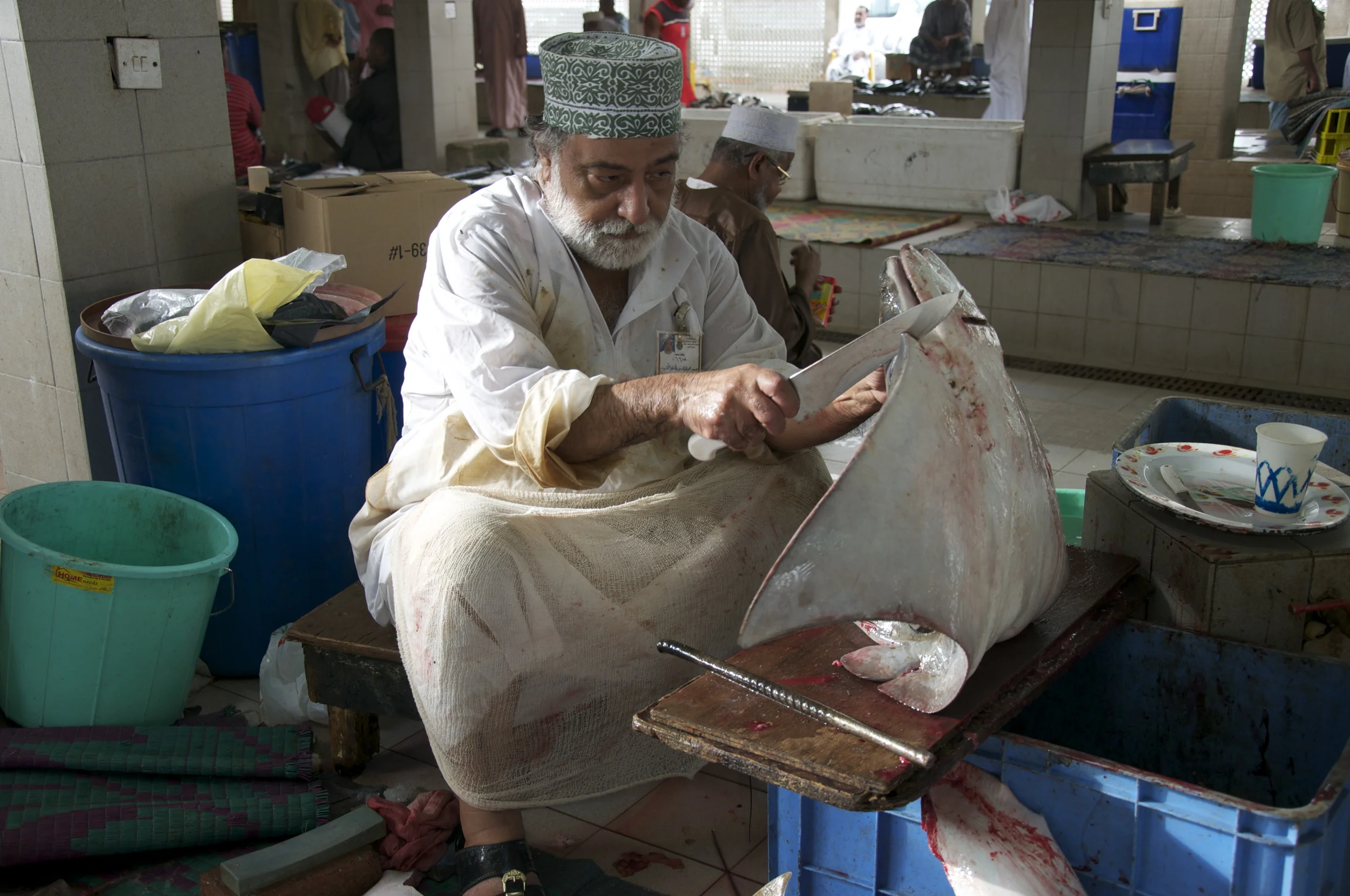 An Omani fisherman cuts skate wings. Photo copyright Meghan Miner Murray.