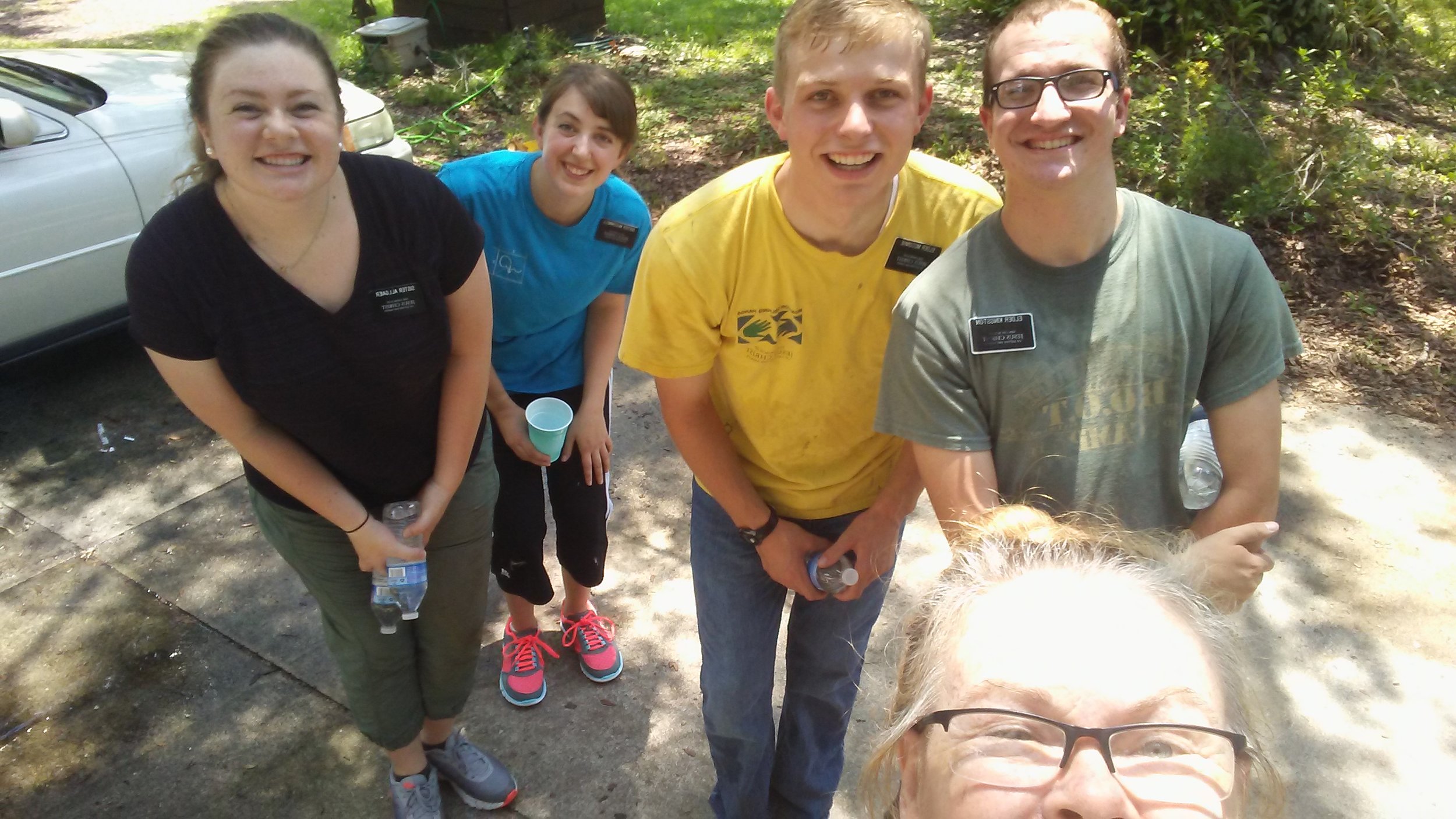 Half of my cute district doing service for the lovely lady in front