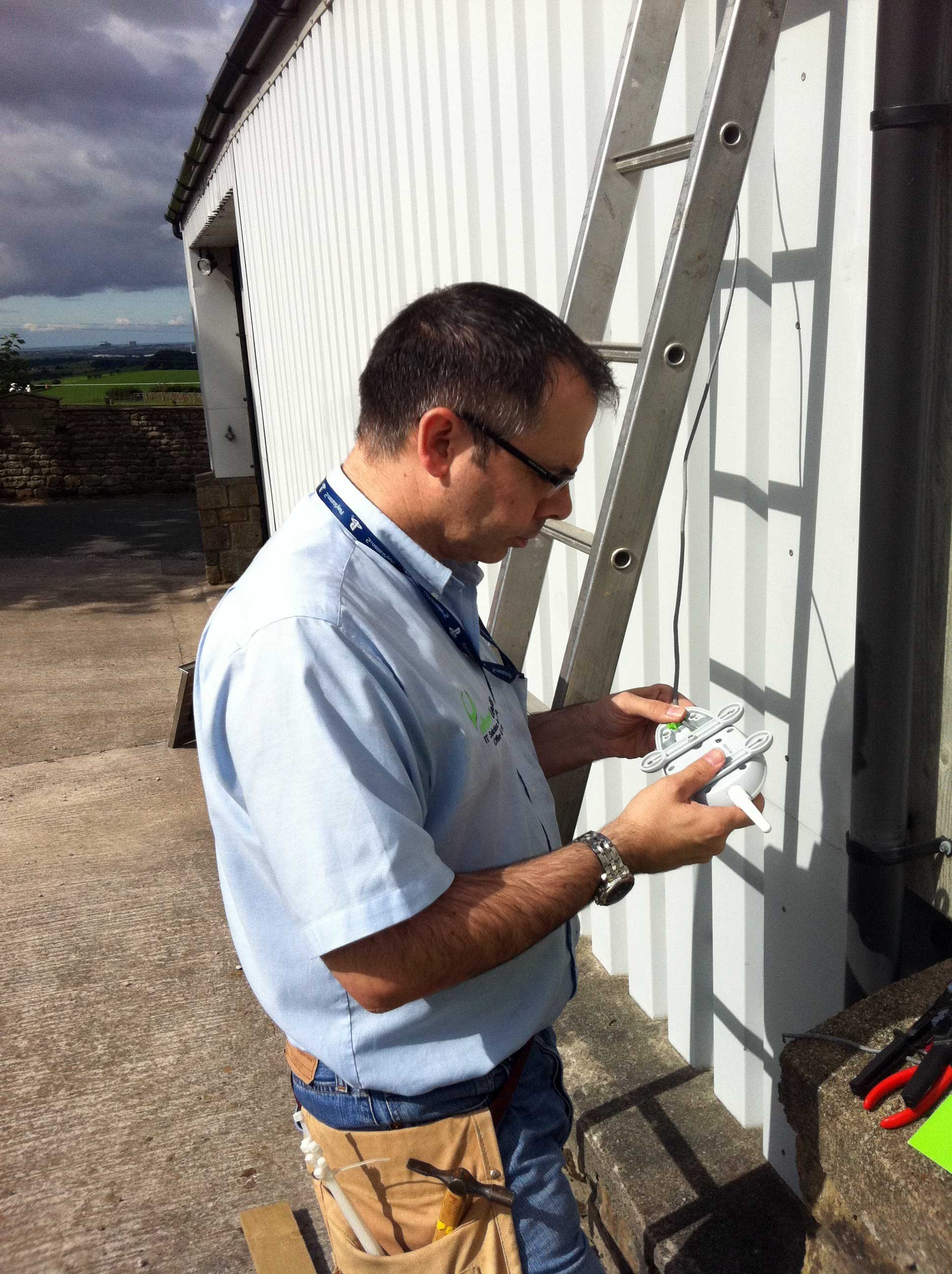 Mike Dent installing Meraki repeater