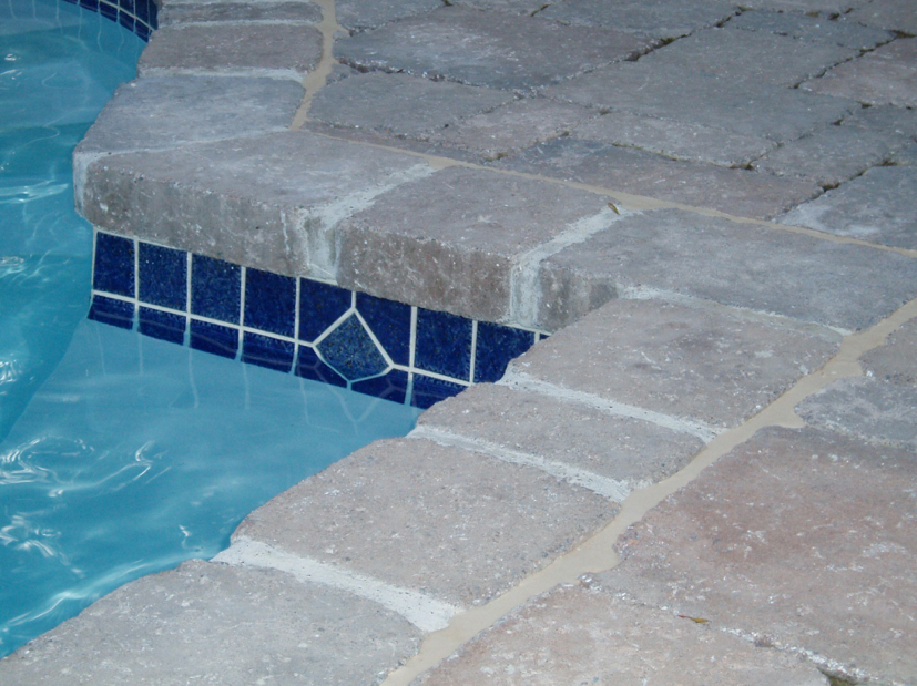 Tri-State project with 3x3 waterline tile and diamond medallions. Tumbled Paver coping, Mega Bergerac 3pc, Brown Flash and Marblewhite Plaster interior finish.