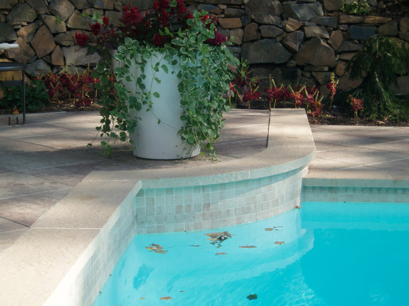 Tri-State project with 2x2 marble waterline tile and raised bond beam. Custom fabricated coping with Marblewhite Plaster interior finish. Custom 18” x 18” paver deck set on a diamond grid pattern.