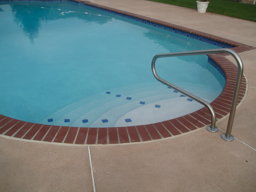 Tri-State project with 3x3 spotter tile trim on steps and 3x3 waterline tile w/diamond medallions. Bullnose Brick Coping, Plantation Red and Diamond Brite interior finish, Super Blue.