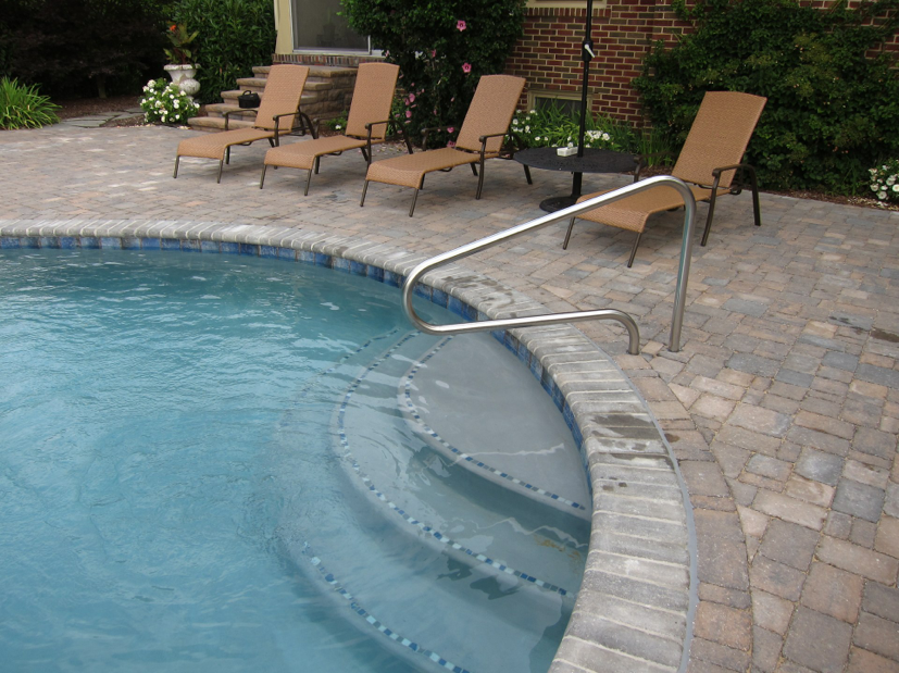Tri-State project with 1x1 tile trim on the steps and 6x6 waterline tile. Bullnose Paver Coping, Sable Blend and Diamond Brite interior finish. Dublin Cobble paver deck, sheffield Blend.