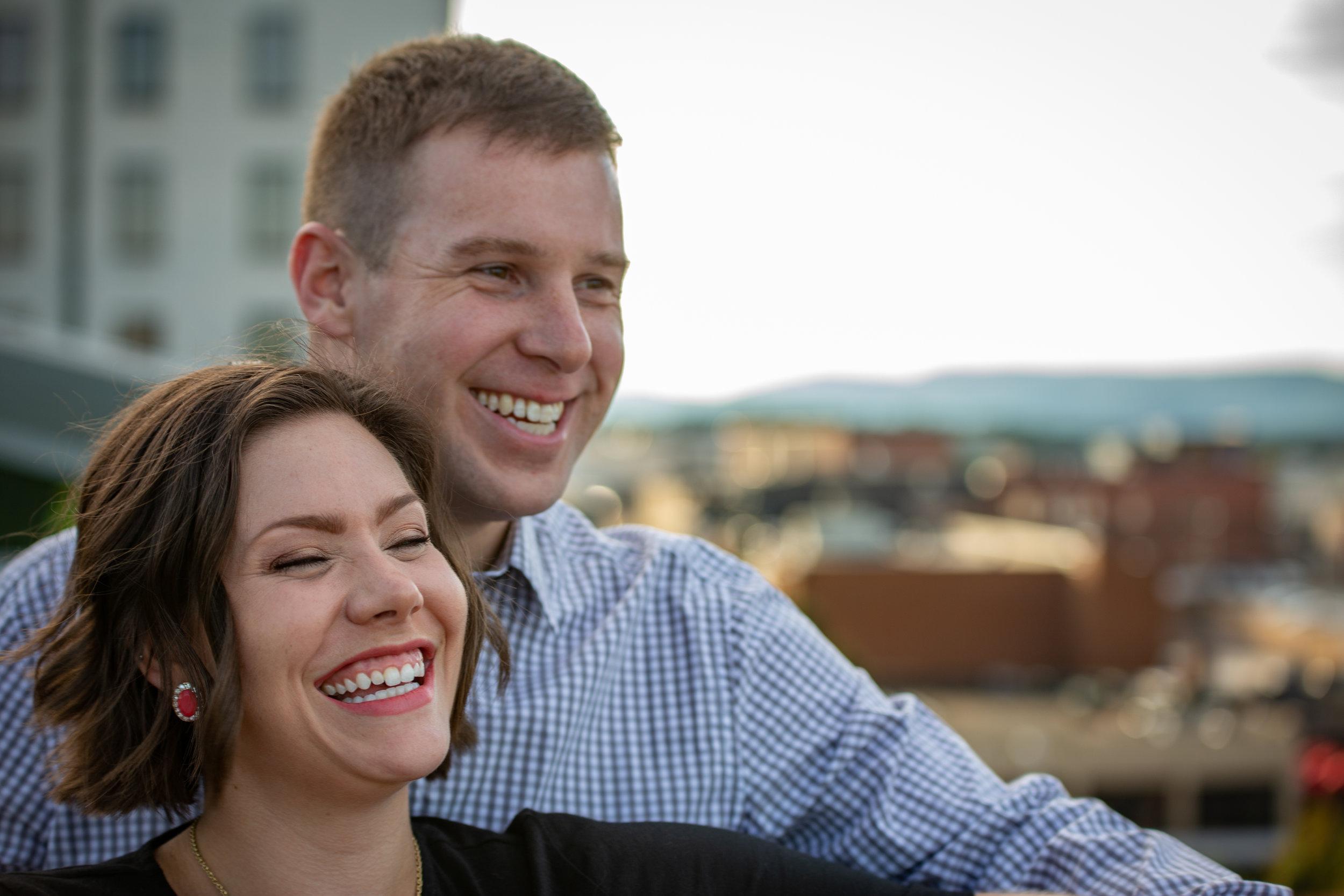 center-in-the-square-downtown-roanoke-urban-rooftop-engagment-wedding-love-couple-smiling-laughing-engaged