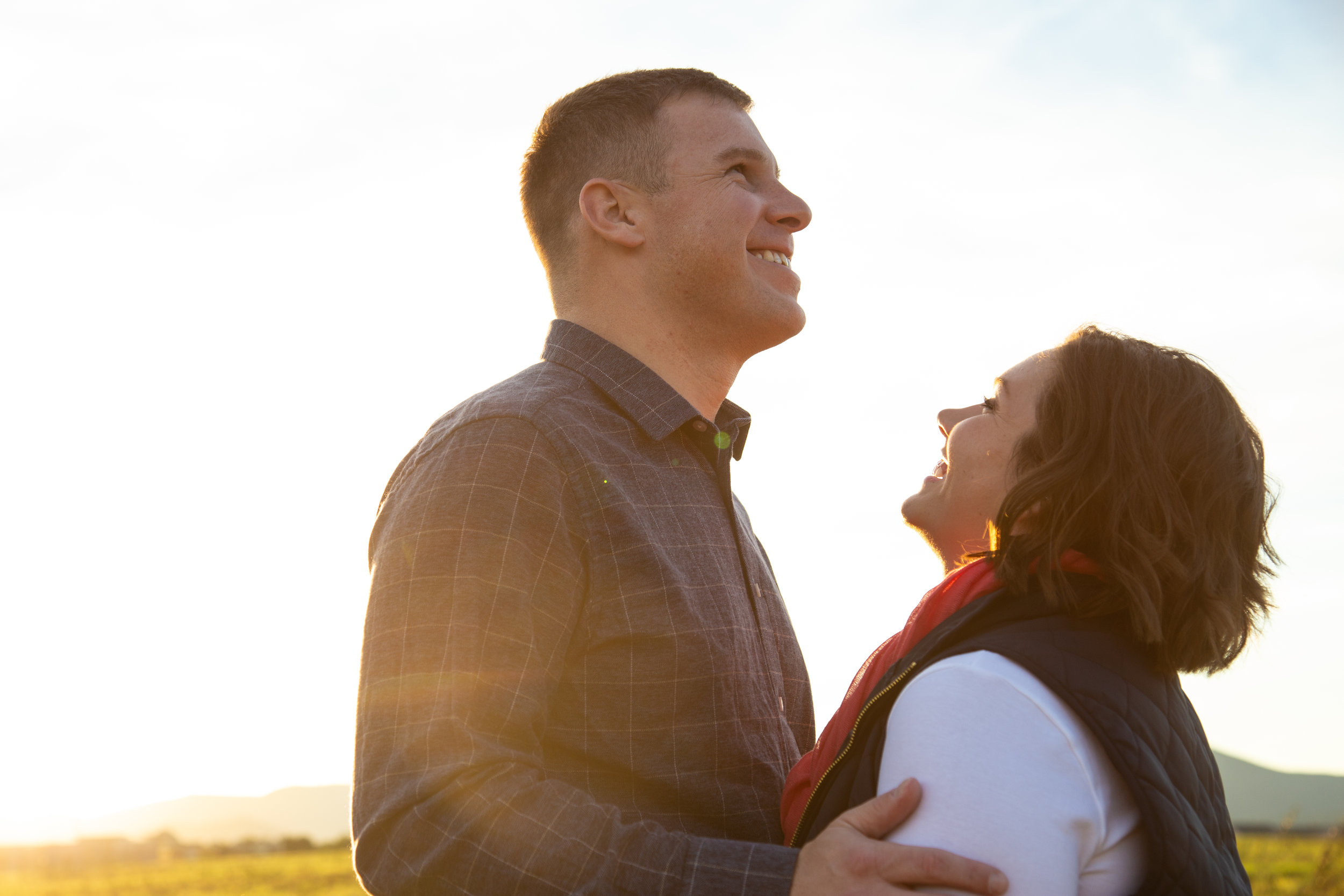 valley-view-shakers-roanoke-engagment-love-couple-outside-sun-flare-warm-love-smile-laughing-mountains