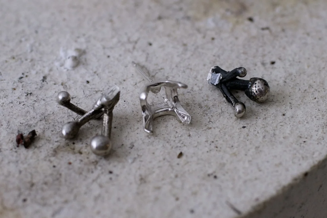 Small organic silver pieces from an earlier casting are cut to fit a stone setting.