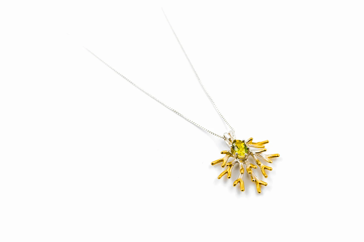 Unfolding pendant with carefully selective oval cut Australian yellow-green parti sapphire.