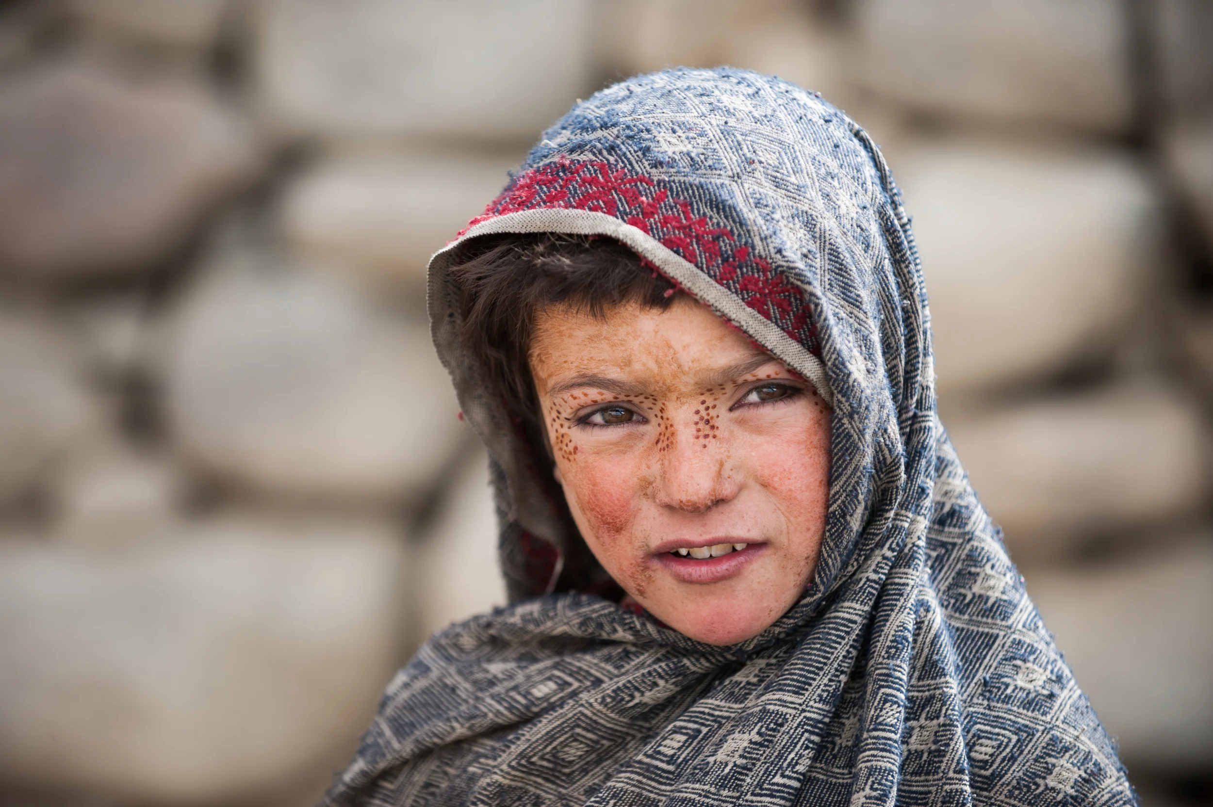 Pakistan A girls face is decorated with Henna in an unusual pattern