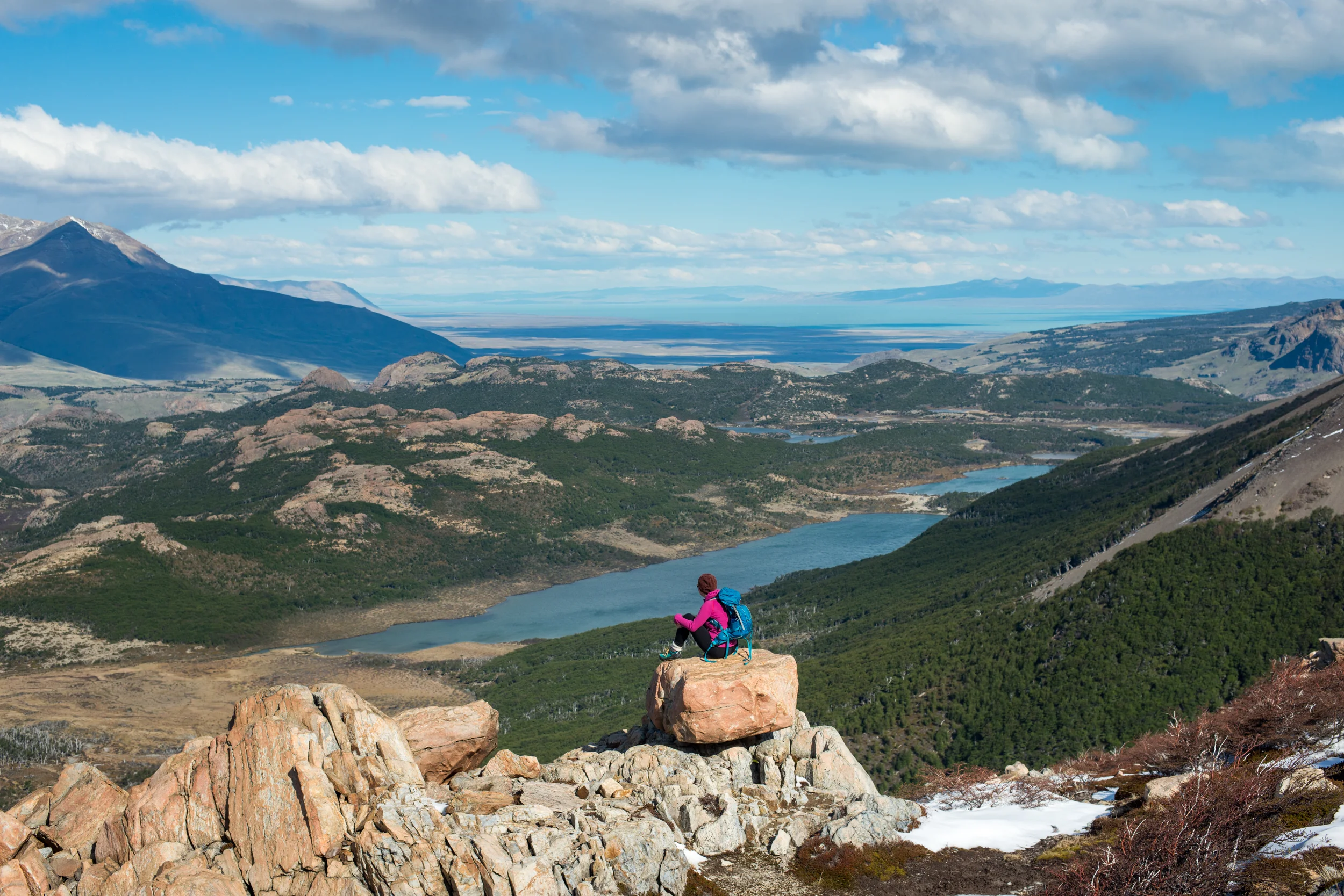 Argentina A woman takes a break from hiking the trail in El Chalten National Park in Patagonia in Argentina to take in the view. Lake Viedma is visible in the distance.
