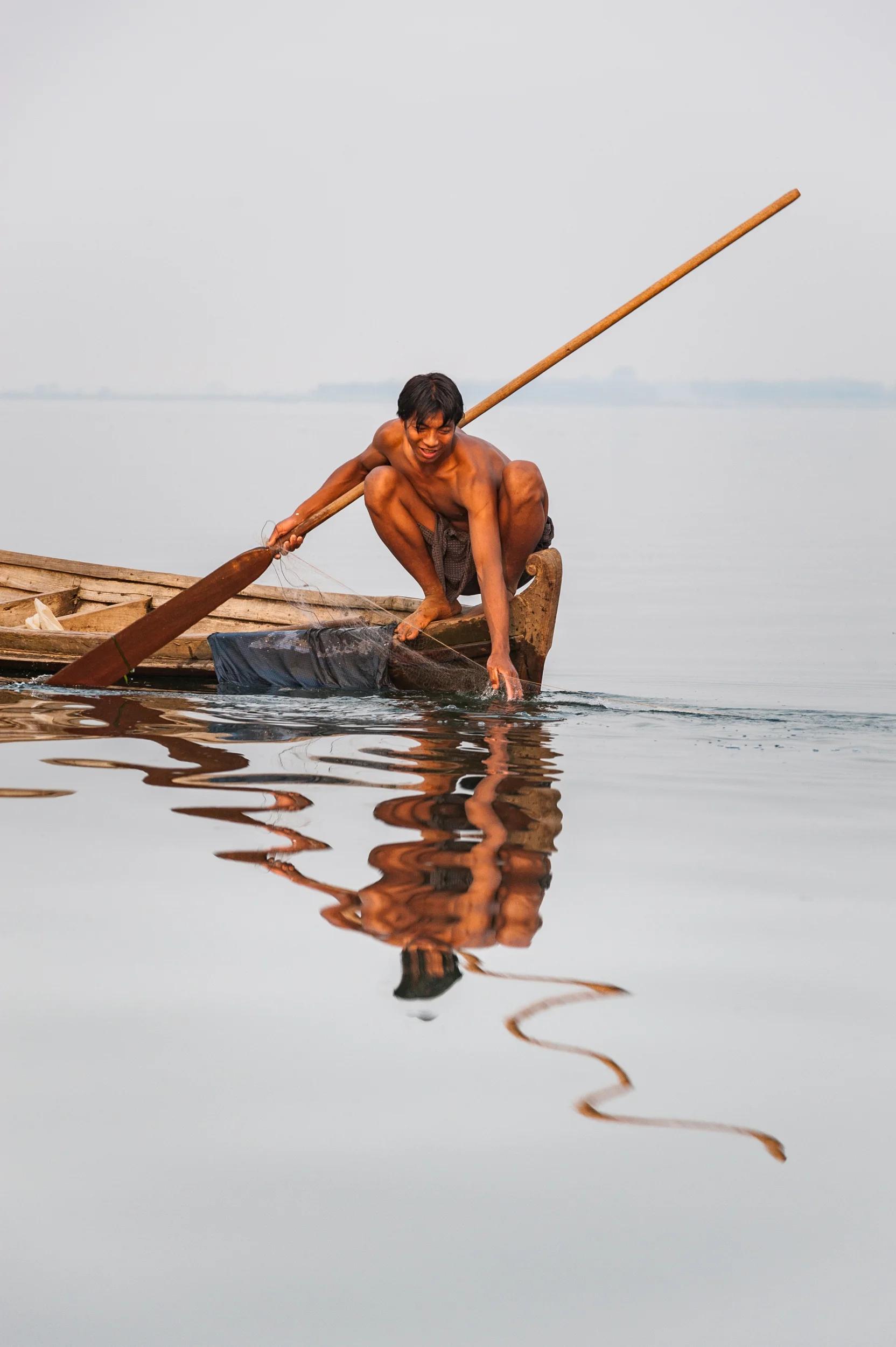 Burma A man pulls in his net on Indawgyi lake, northern Burma.