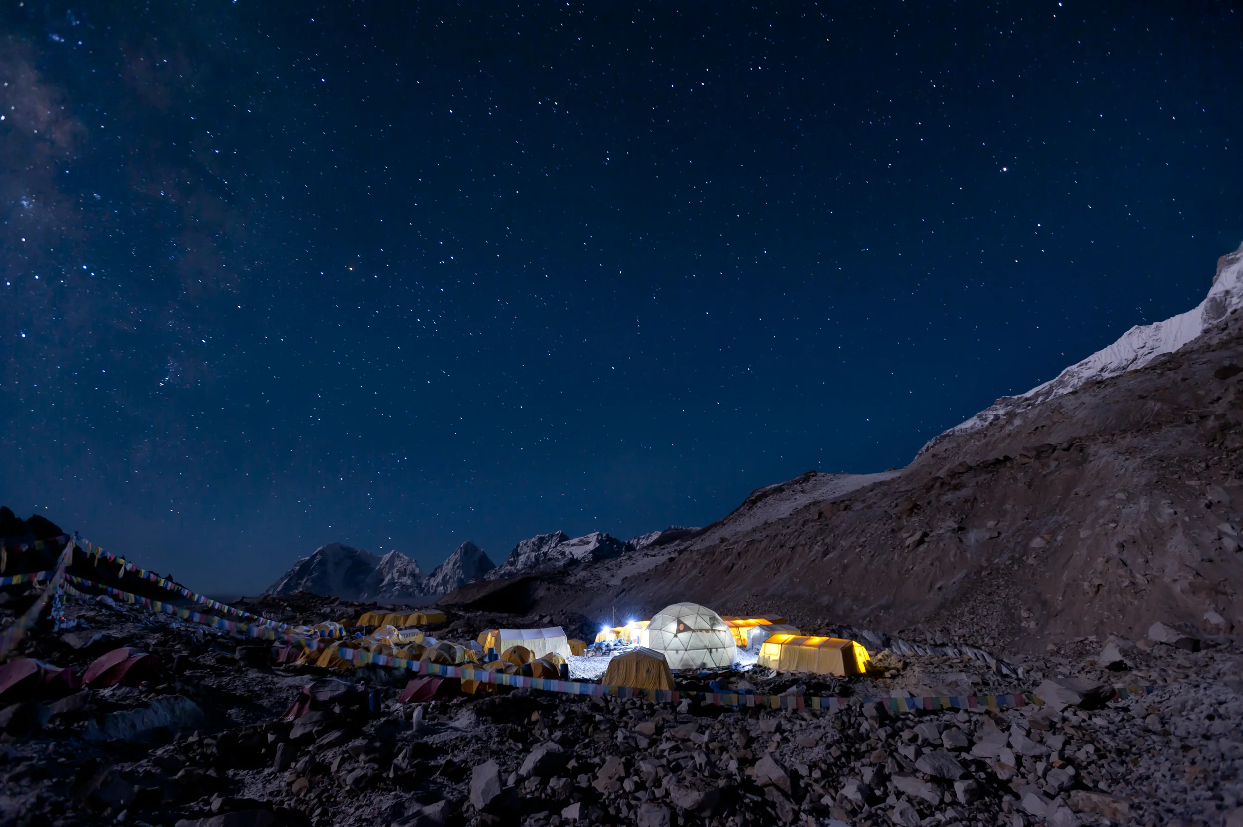 Nepal Climbers prepare to leave Everest base camp in the middle of the night for their summit attempt. The Milky Way is visible above the Khumbu glacier.