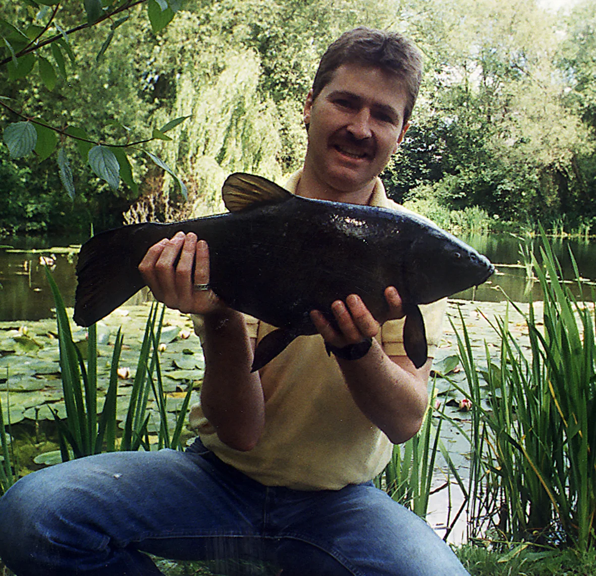 Me, when I was young! A 7lb 10oz tench caught on a single grain of corn between the lily pads.