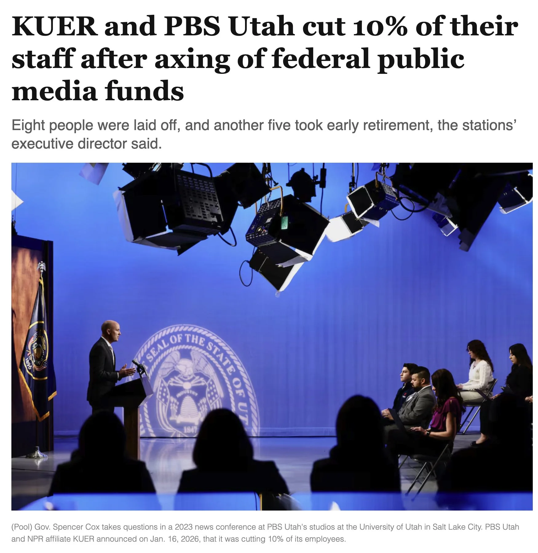 A screenshot from an article by The Salt Lake Tribune announcing layoffs at PBS Utah and KUER Radio featuring an image from the Governor's Monthly News Conference.