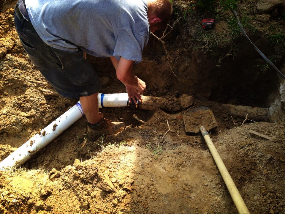 Worker installing septic pipe | Shore Quality Contracting, LLC