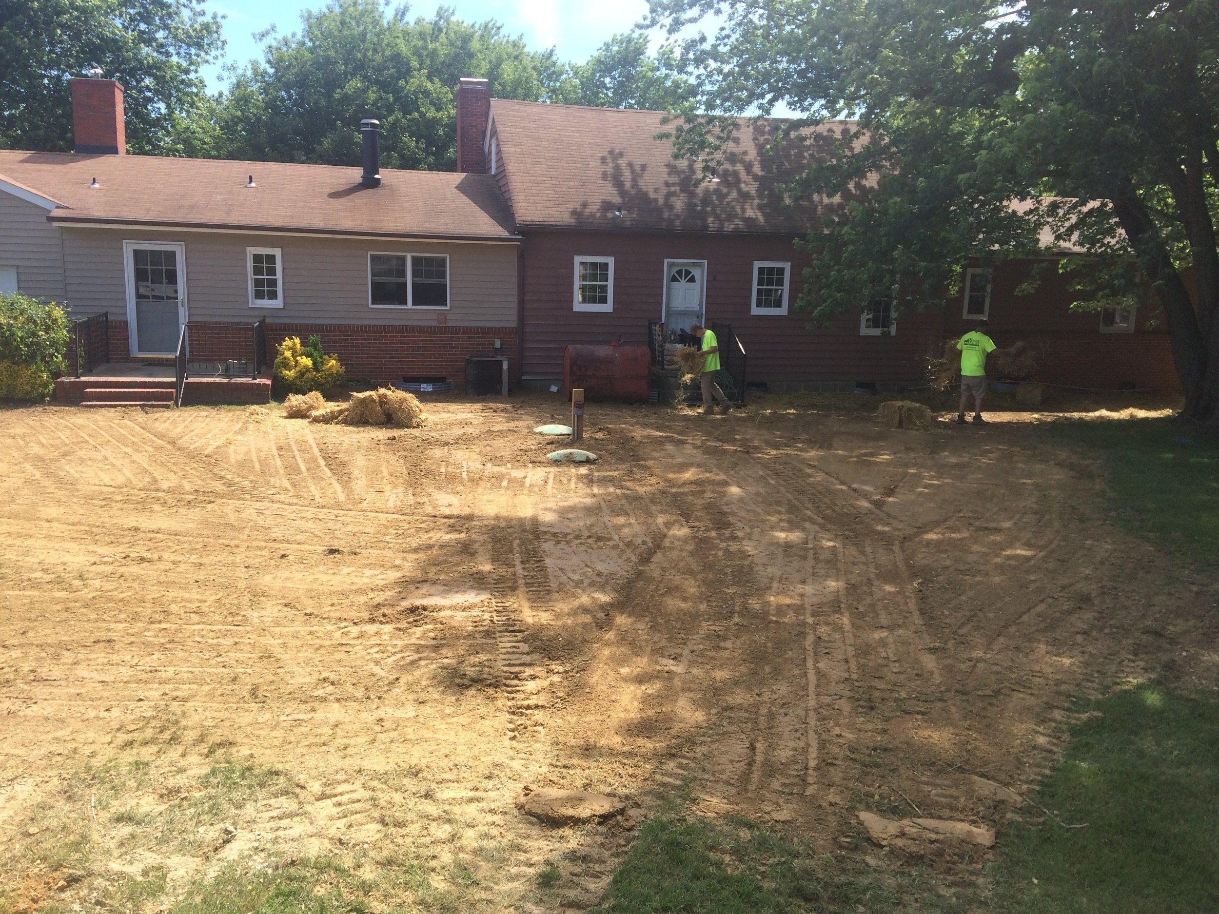 Workers grading yard post septic installation | Shore Quality Contracting, LLC