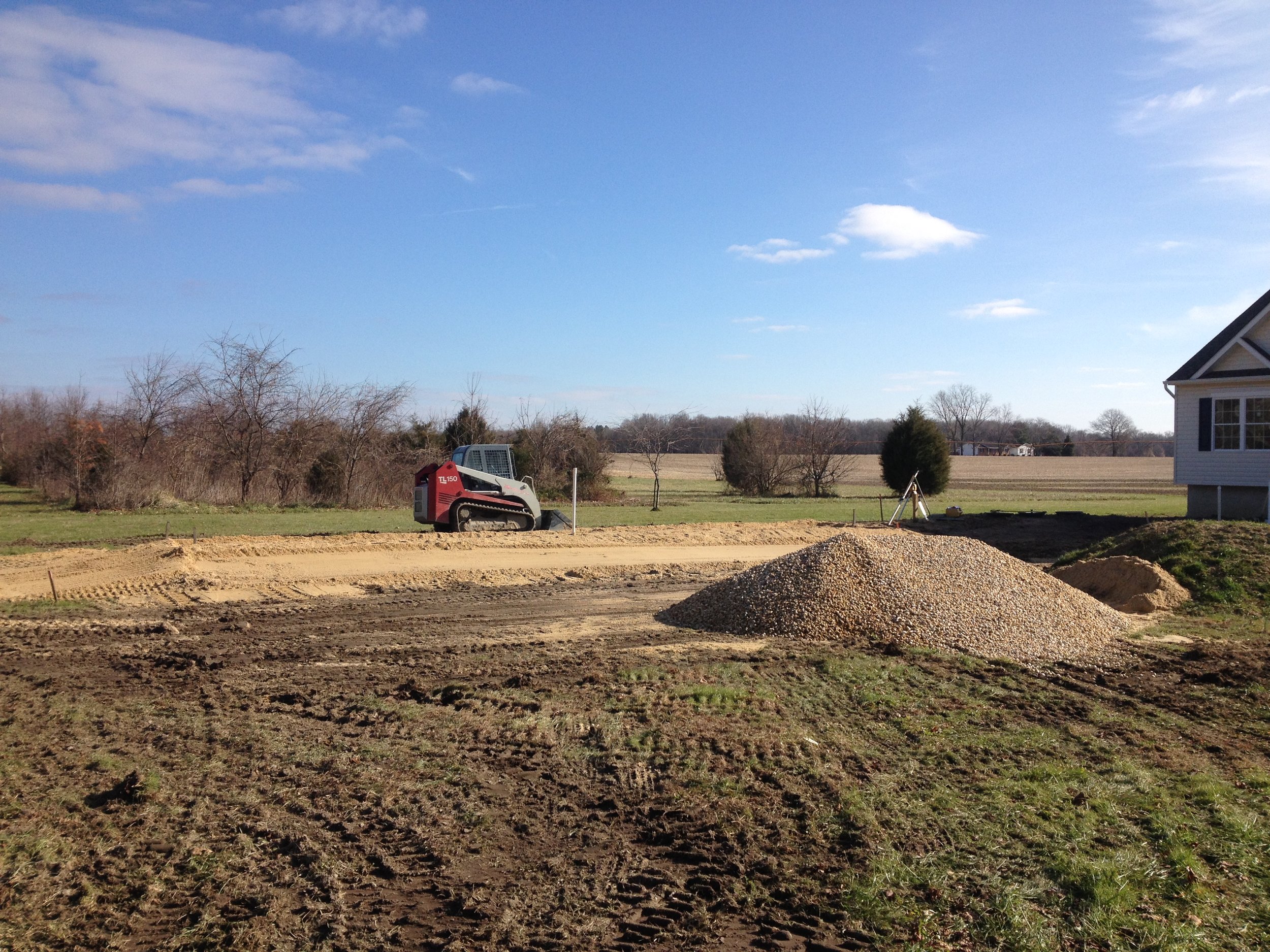 Track loader in distance | Shore Quality Contracting, LLC