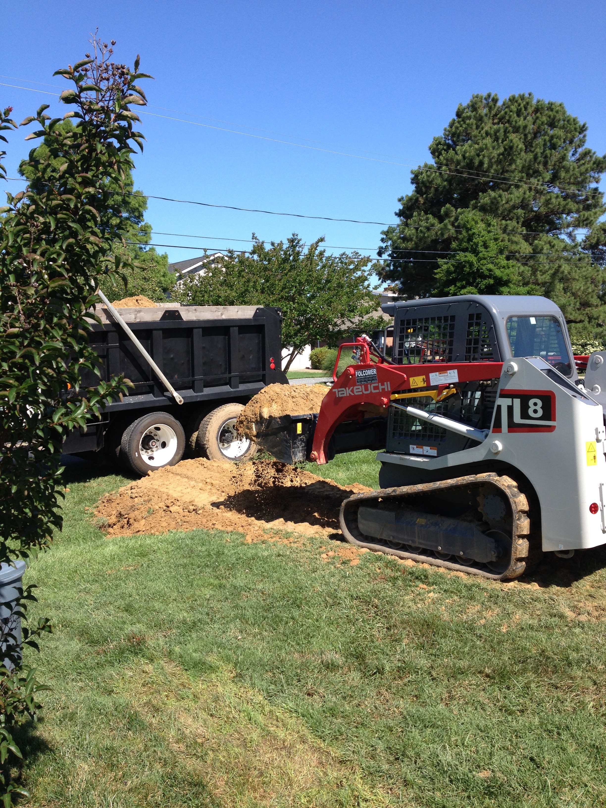 Loading dirt into dump truck | Shore Quality Contracting, LLC