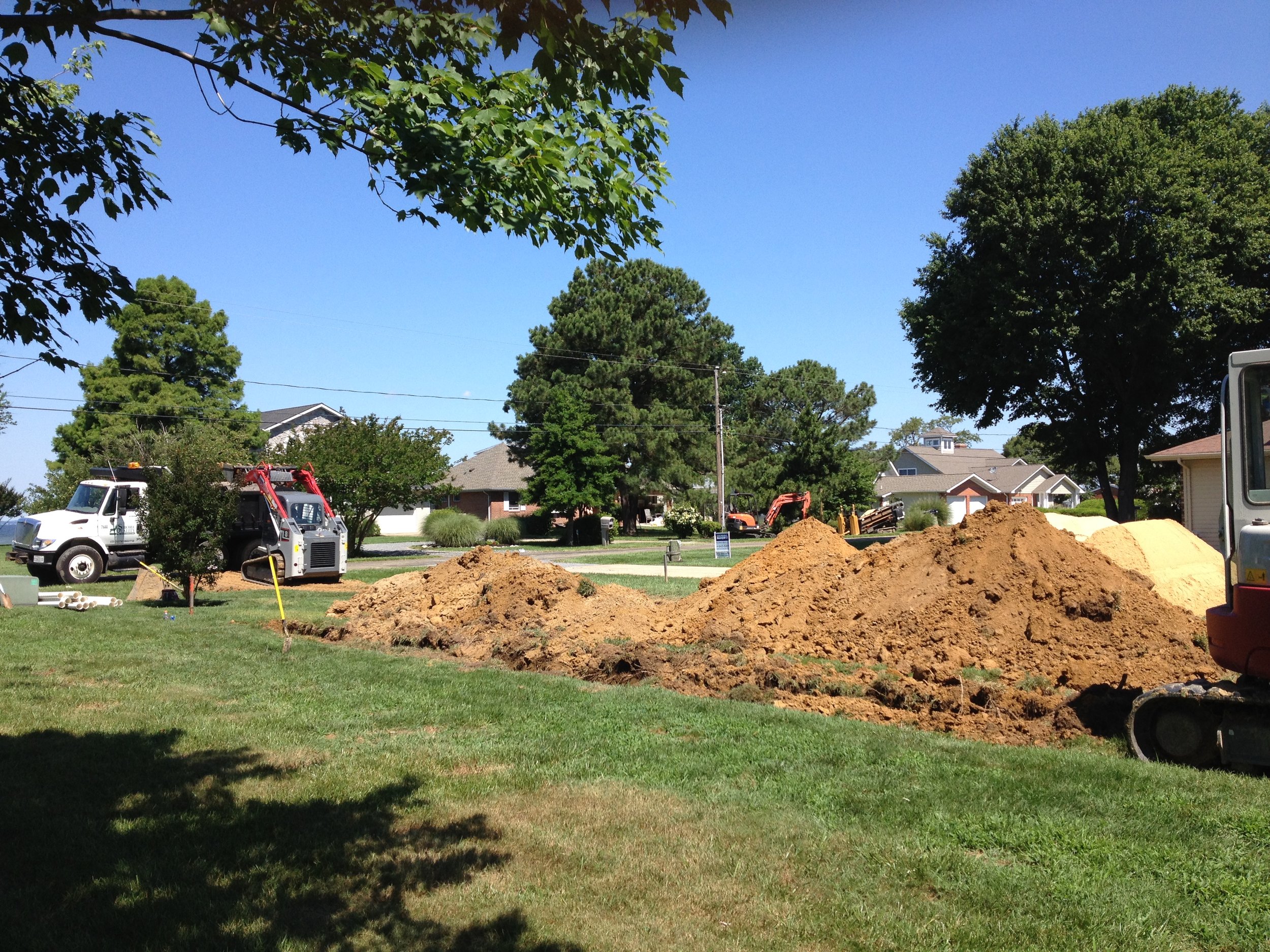 Loading dirt into dump truck | Shore Quality Contracting, LLC