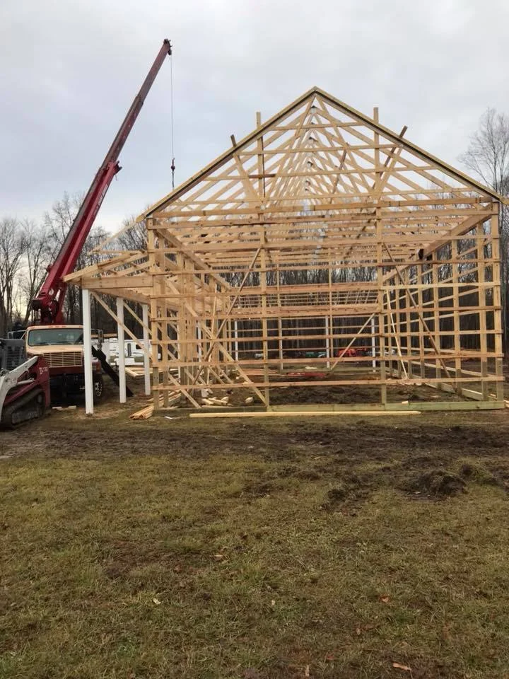 construction of pole building install of wood trusses with crane