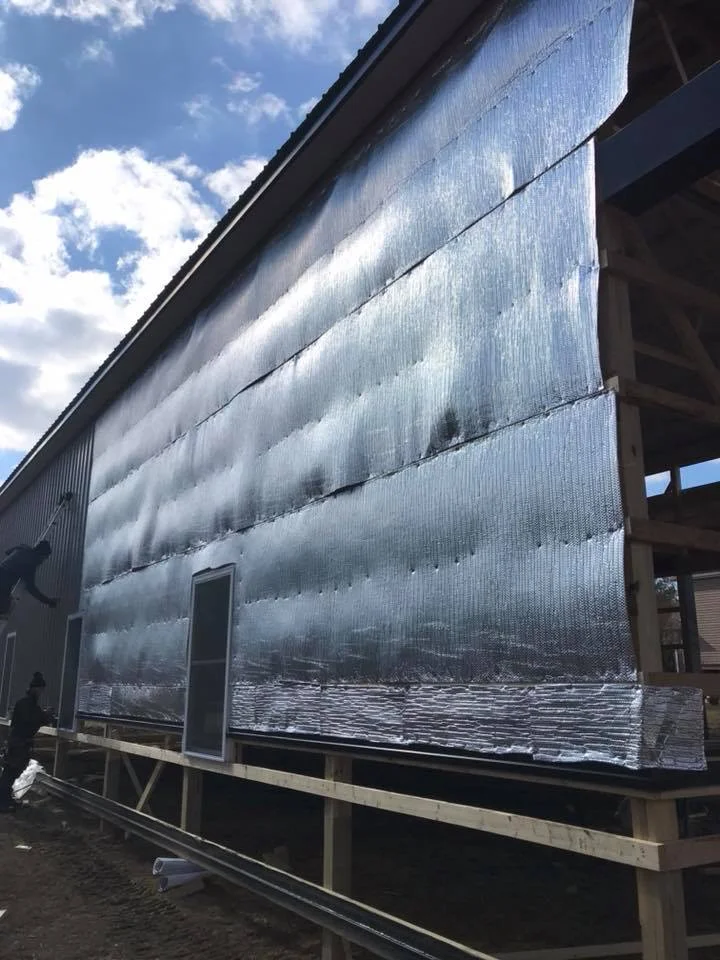 construction of pole building close view of metal siding install