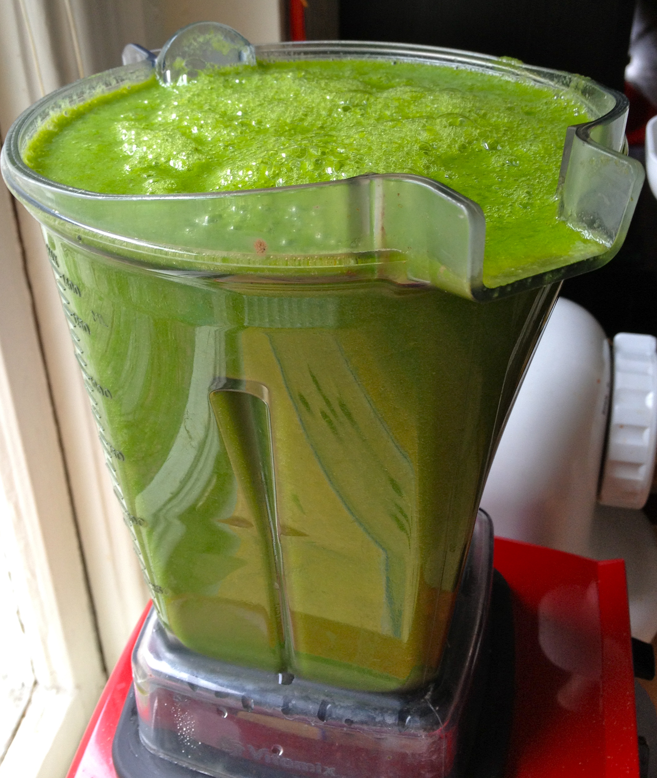 A high-powered blender makes all the difference when blending fibrous greens. Green smoothie with romaine lettuce, cucumber, celery, lemon, apple, and banana. 