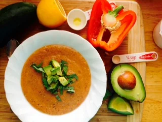 Gazpacho topped with avocado and basil. 