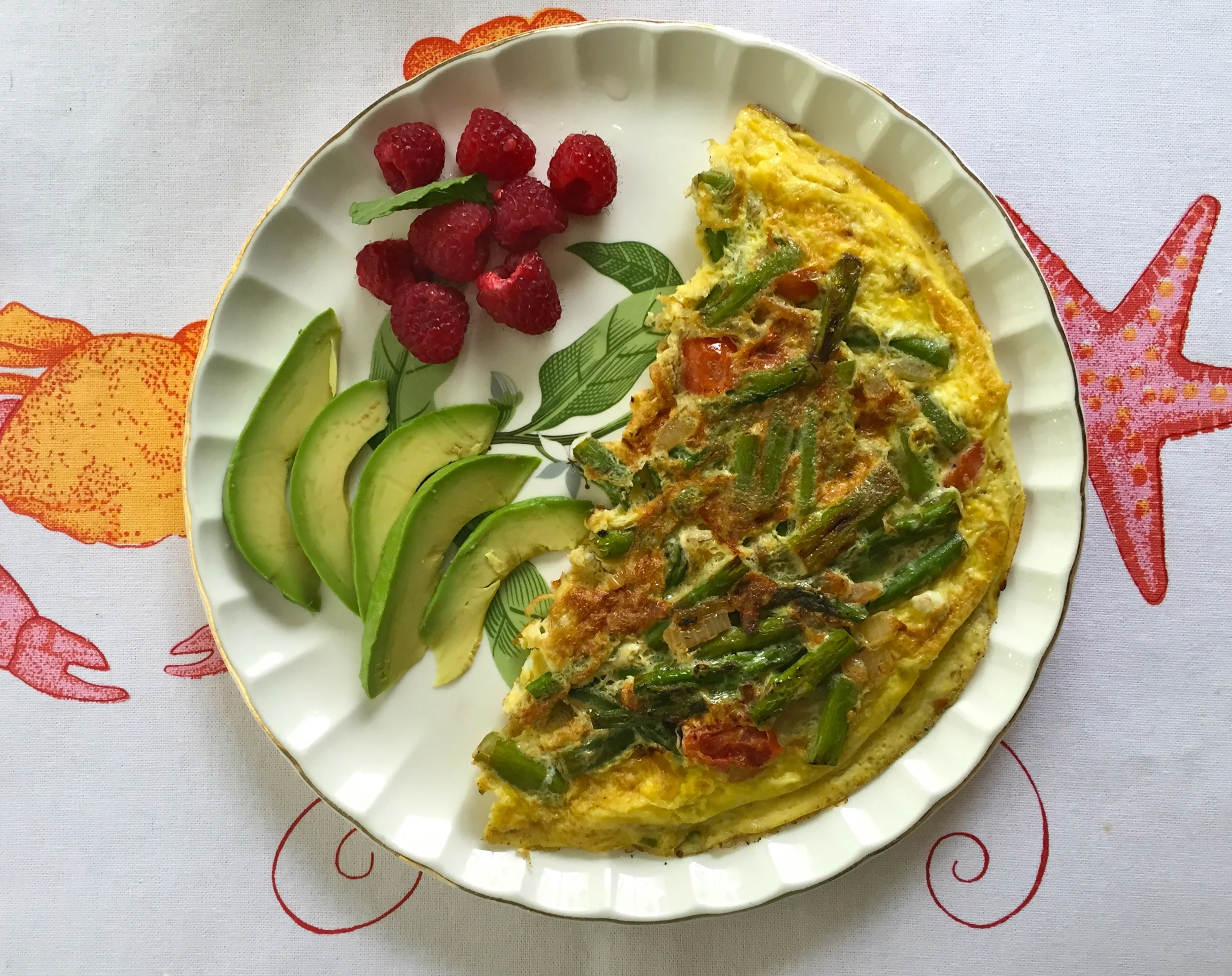 One of the best parts about being home? Mom cooking for me! Veggie omelette with asparagus and tomato, plus a side of avocado and raspberries. 