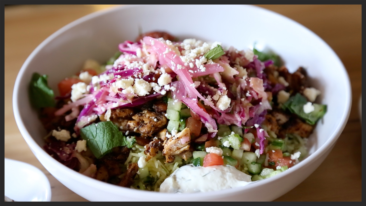 Pictured: Rice bowl with Chicken, Cucumber, Cabbage Slaw, and Feta from Cava Mezze Grill | Foodable WebTV Network