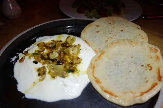 Whipped Goat Cheese from Drake Family Farm with walnut-black garlic pesto, tomatillo, flatbread | Foodable Network
