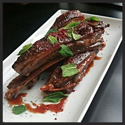 Baharat spiced lamb ribs, pomegranate molasses, mint and marash pepper at Levant | Facebook, Levant