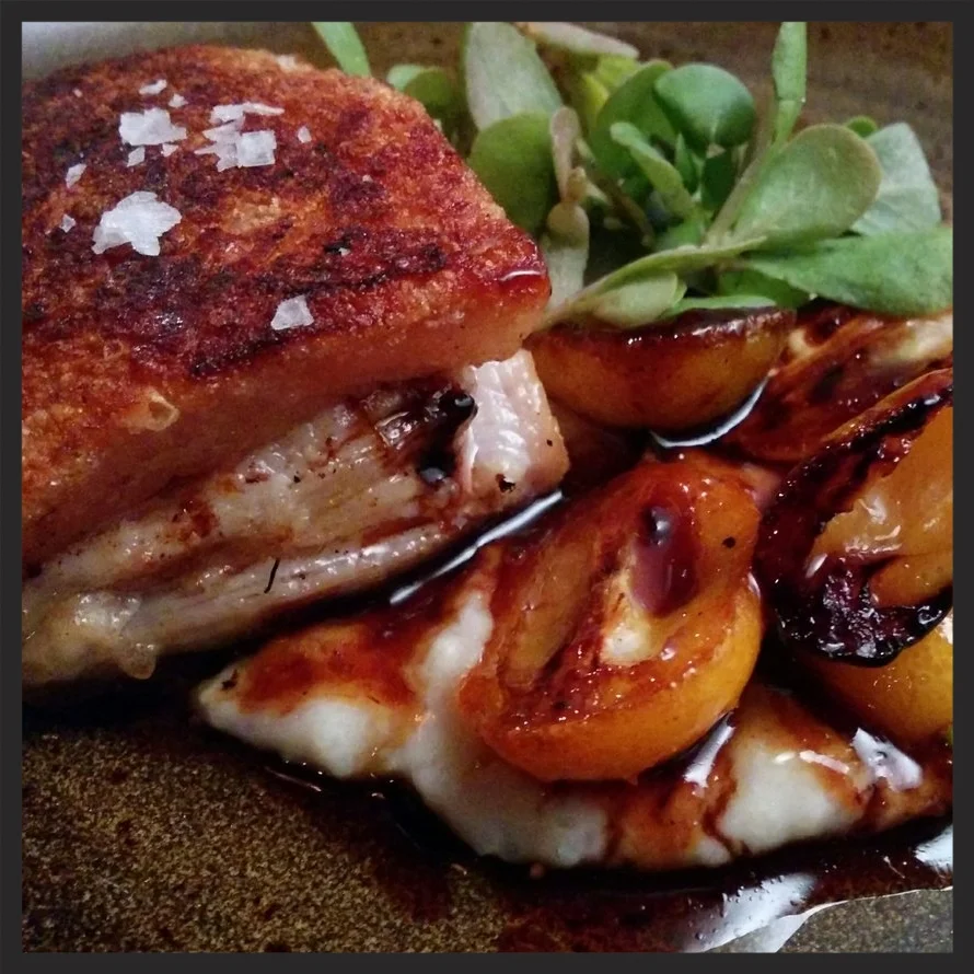 Crispy pork belly with Anson Mills grits and kumquats at Alden & Harlow | Credit: Yelp, Marko M.
