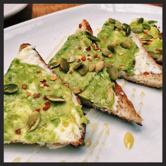 Whipped goat cheese, smashed avocado, honey, toasted pepitas, chili flake on grilled toast at Townhouse | Instagram, @itsbeals