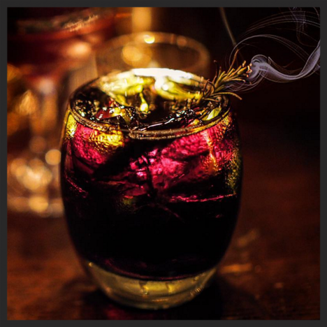 Le Vamp Noir cocktail at Justine's Brasserie (black rum, fernet, creme de cacao, Angustura bitters, rosemary on fire) | Instagram @justinesbrasserie