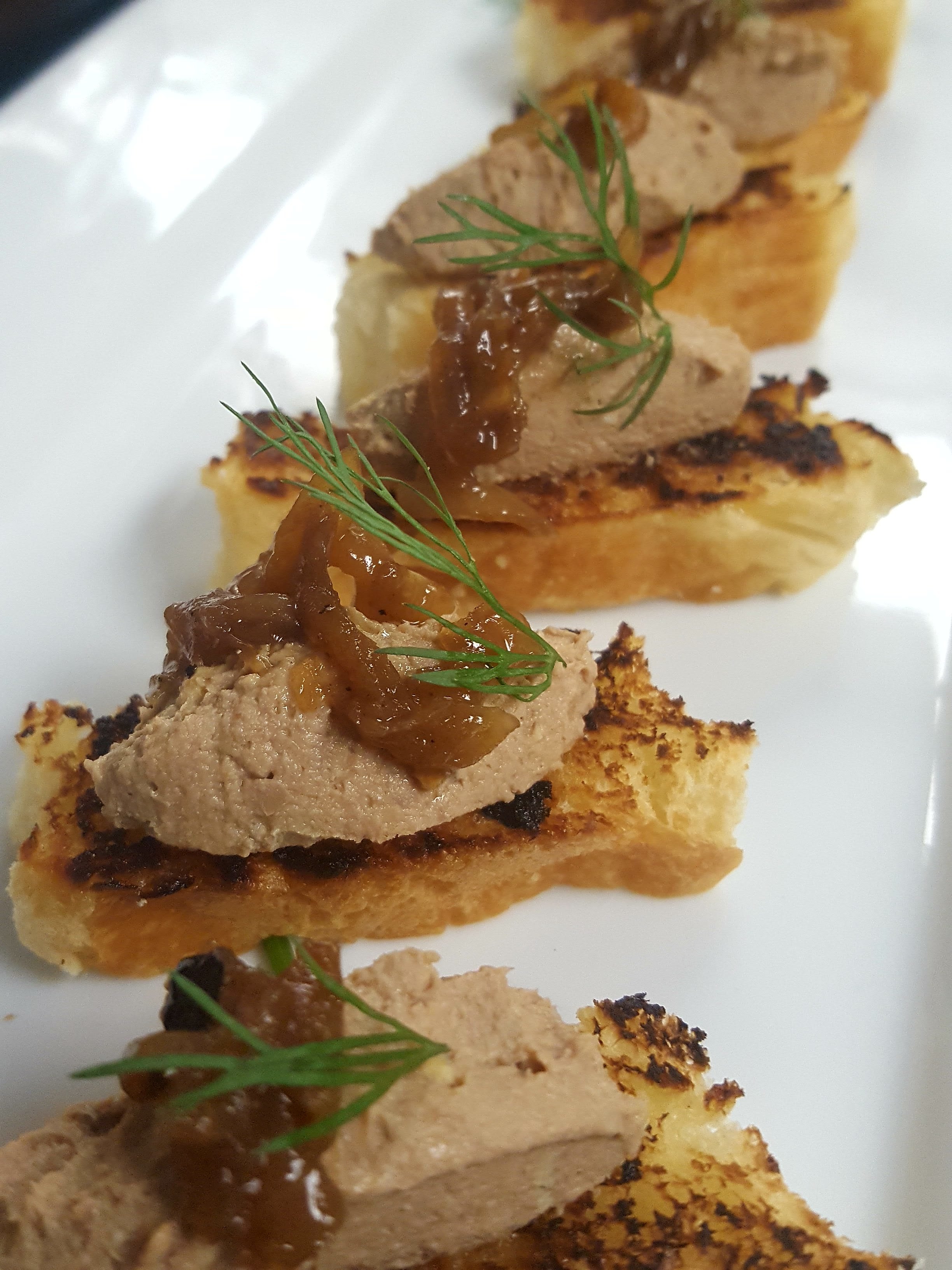 Chicken liver on schmaltz-grilled bread topped with caramelized onions | Jim Berman