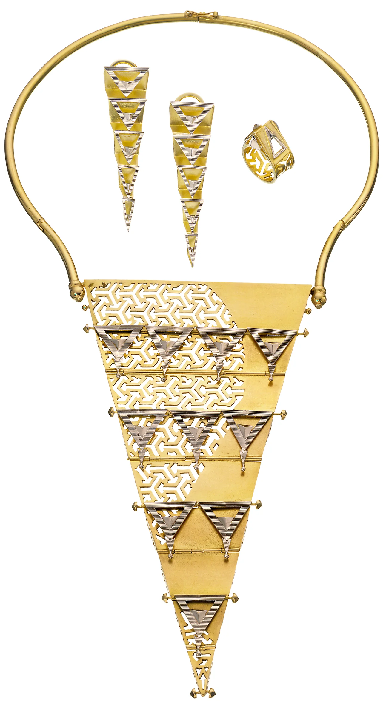 Image: ‘Gold Virtuosi’ ensemble by Reena Ahluwalia. 18K white and yellow gold. 12 inch necklace transitions from 2D to 3D. Composed of diagonal planer elements and triangles; each plate is hinged and folds like pleats to create a 3D form. Inspired by Pragati Maidan , a large convention center in New Delhi, India. The impression it left on me, resulted in a gold jewel. I found the interplay of open and closed spaces fascinating, as they almost assume human qualities. A meeting place, coming together of minds, blending and forming.