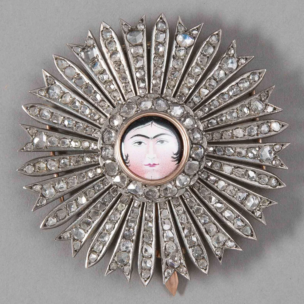 Medal Of The Qajar Order Of The Sun. 19th Century AD / 13th Century AH. The central enamel roundel bearing the face of the female sun (aftab), emanating diamond-set rays. Image: Islamic Art Museum Malaysia