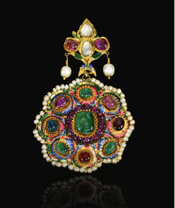 A large Qajar polychrome enamelled and gem-set gold pendant, Persia, 19th century of flowerhead form, the central raised emerald encircled by rubies, each petal with enamelled blue or pink ground surmounted by a ruby, emerald or sapphire, with a seed-pearl border, the reverse with polychrome enamelled design of birds and a butterfly amidst floral motifs, surmounted by a gem-set and enamelled bud-shaped section. Image: Sotheby's