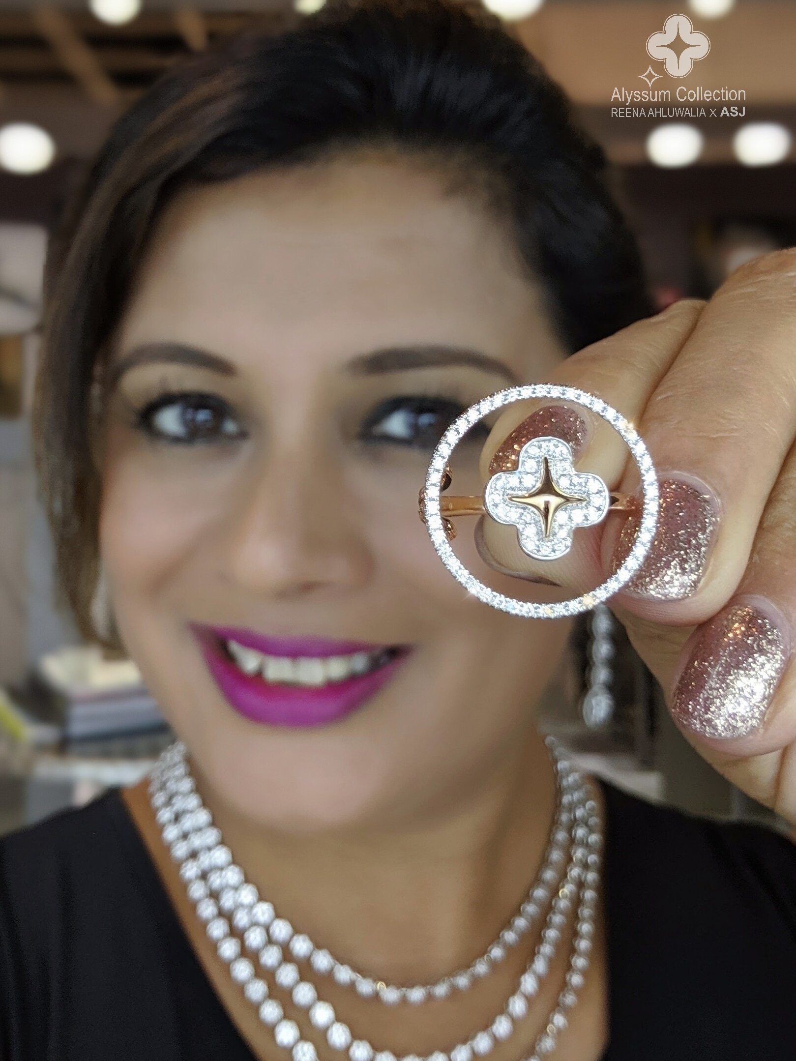 Reena Ahluwalia holds an Alyssum diamond ring and earrings.