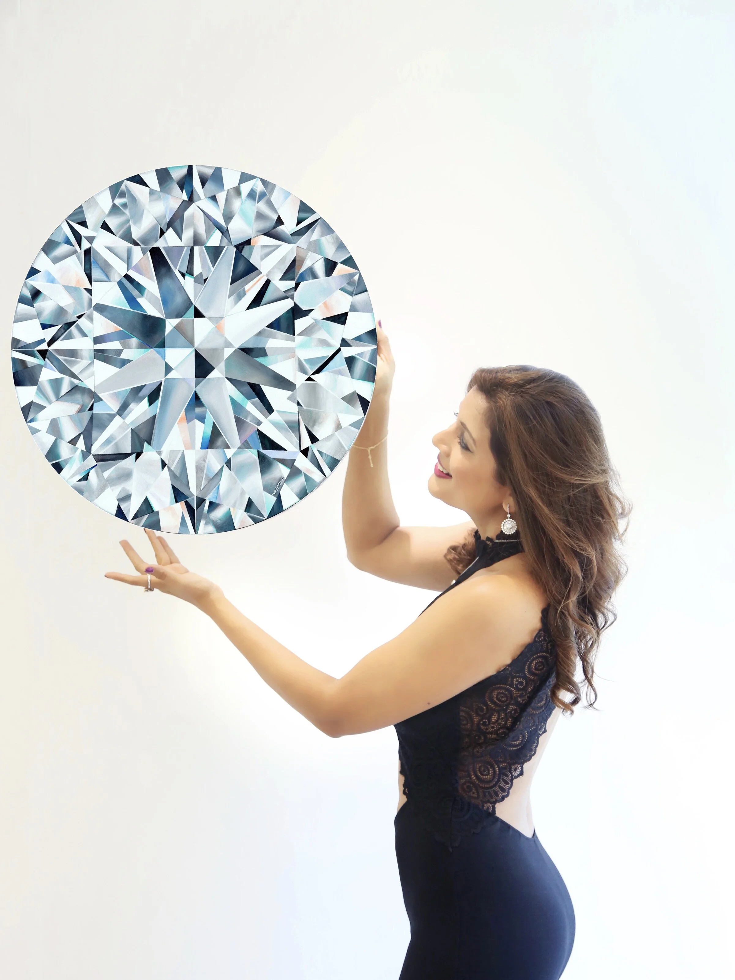 Reena with one of her round brilliant diamond painting that is featured on the watch dial.
