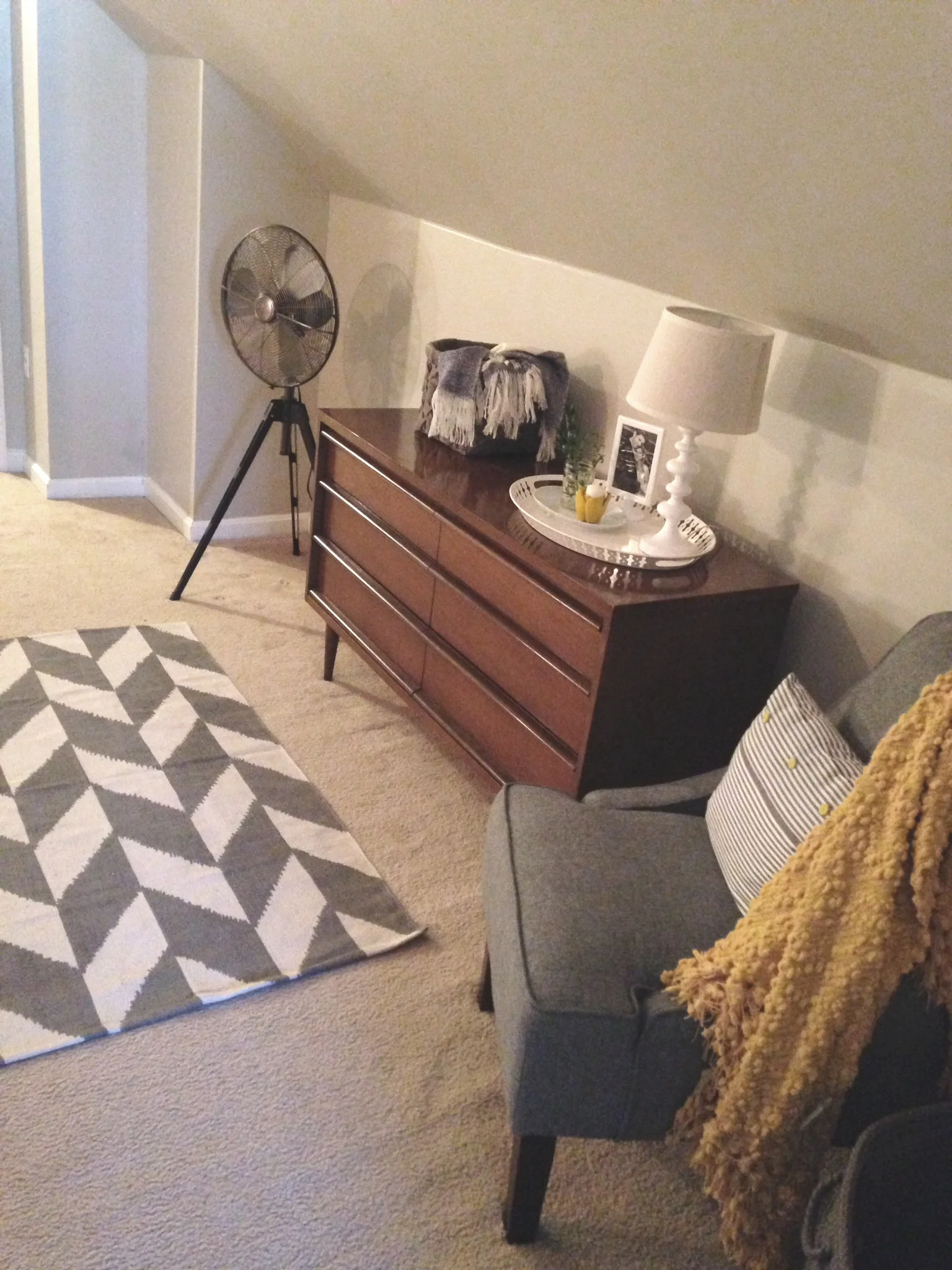 Here is the aforementioned dresser and a chair I picked up for cheap at Target. I made the throw pillow from a pillow case I got for a couple bucks in the IKEA as-is section. The Hunter fan was on end of season clearance at Target for less than $30. I love it.