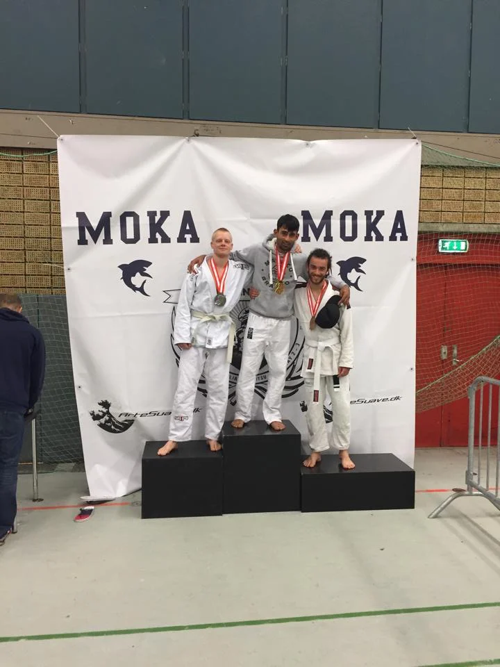 Suk and Valentin on the podium after their fights in the Adult White Belt Featherweight division.