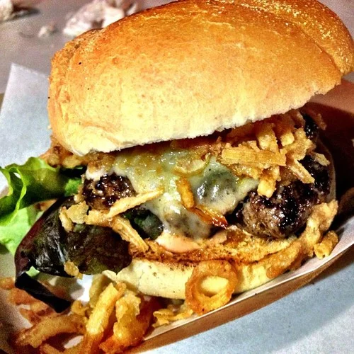  Handformed ground beef patty seasoned with secret Swedish spices on a sesame roll with white sharp cheddar cheese, fried onions, lettuce and tomato