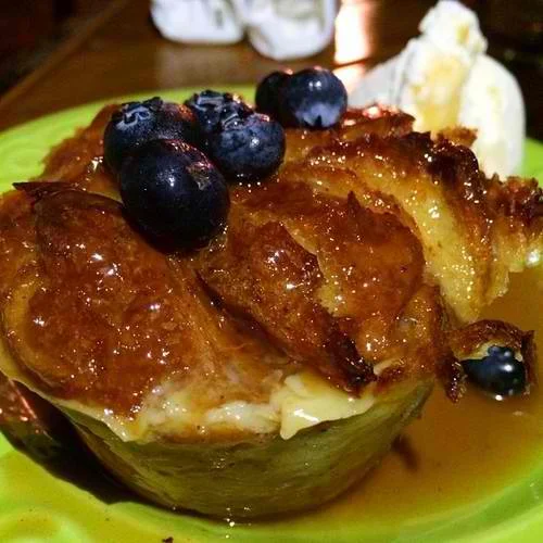 Baked with fresh croissants and drizzled with a caramel bourbon glaze then finished with a scoop of English custard ice cream and fresh berries