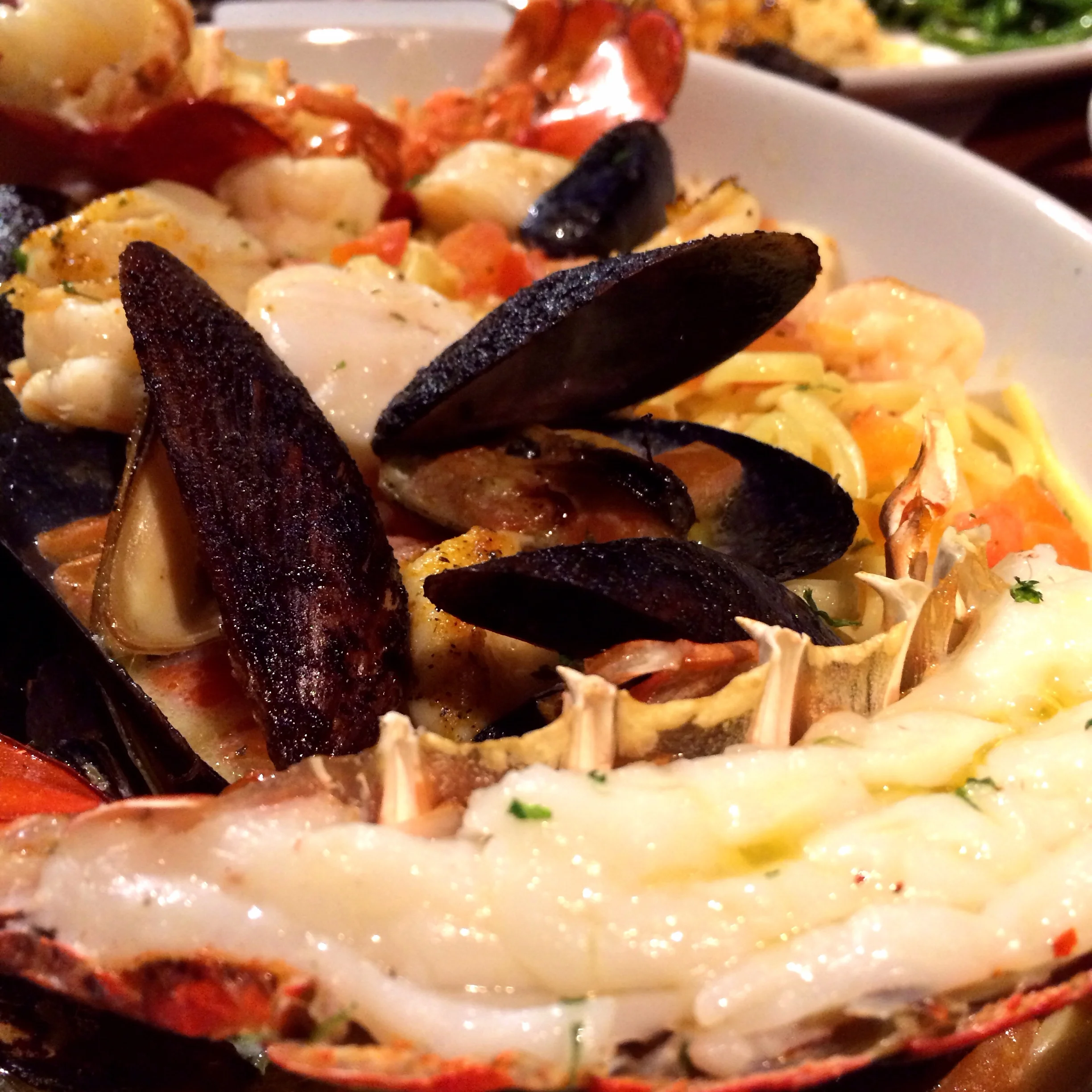 Bar Harbor Lobster Bake. A roasted split Maine lobster tail, tender shrimp, sea scallops, mussels and linguini in a garlic and white wine broth 