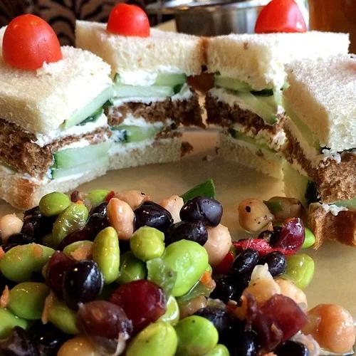 Cucumber and cream cheese served classic tea-sandwich style: triple-decker white and wheat triangles sans crusts. 