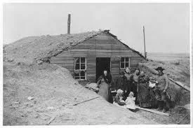 Hoglunds built-up dugout may have looked something like this. They extended the stone walls upward, installed a ridge pole to anchor the roof, and sodded the slopes to keep out the rain and snow.