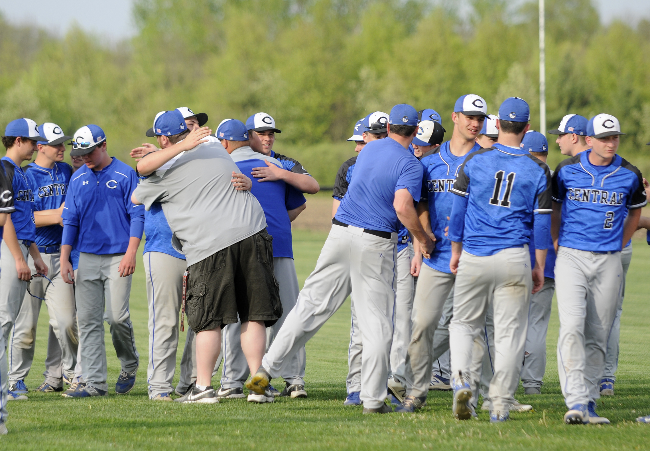 Clifton Central Comets players and coaches embrace Monday after a 14-0 lose to the Bishop McNamara’s Fightin’ Irish. 