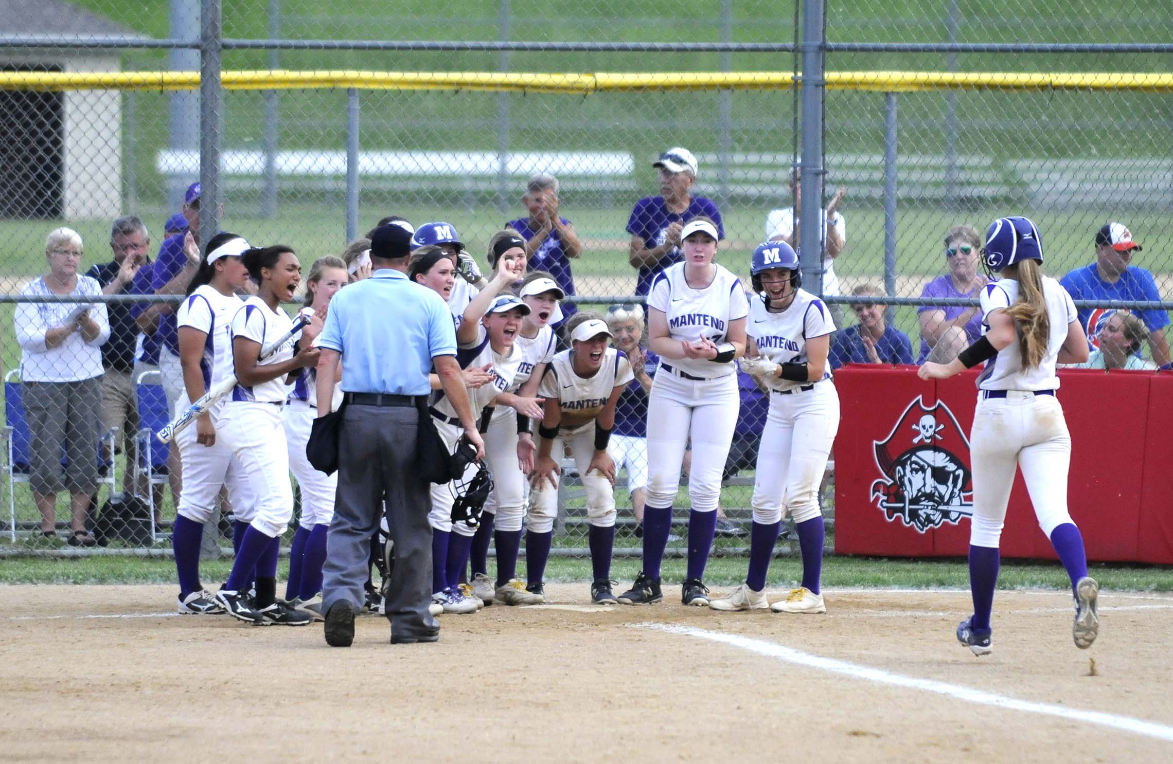  Manteno player Kori Fricke is greeted by teammates at home plate after hitting a home run Tuesday at Ottawa High School.    