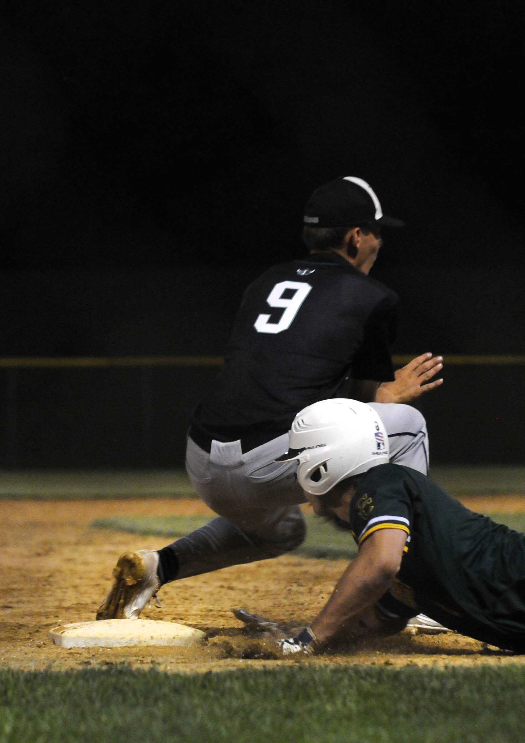  Coal City player Austin Pullara slides safely to third base after trying to steal home Thursday during a game at Ottawa High School against Illiana Christian. Coal City beat Illiana Christian 3-1.    