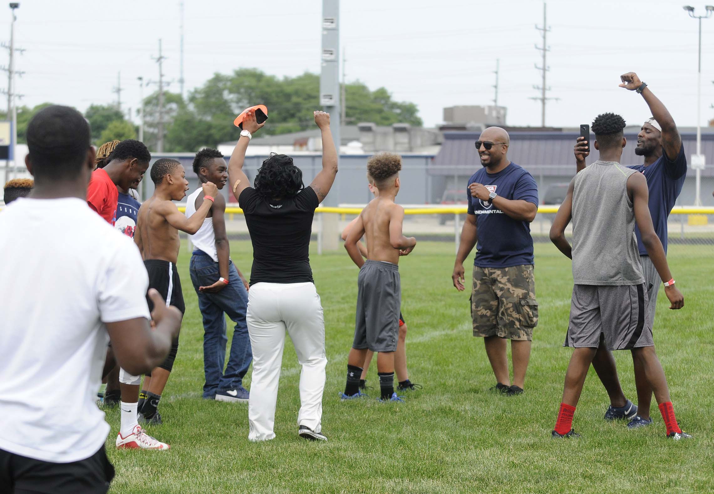  Participants in Haglers 12th Annual Kidz-Kan-Do Football and Cheerleading Camp cheer after a touchdown Saturday on the football field at Bishop McNamara High School in Kankakee. Football drills, separated into age groups, took place on the field lea